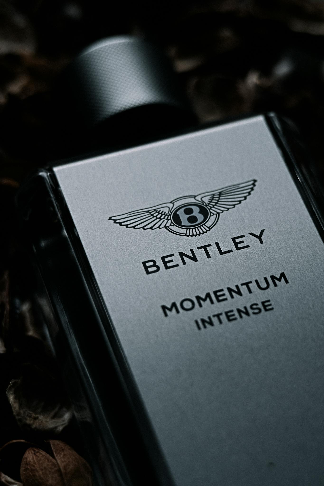 Close-up of Bentley Momentum Intense perfume bottle showcasing luxury design.