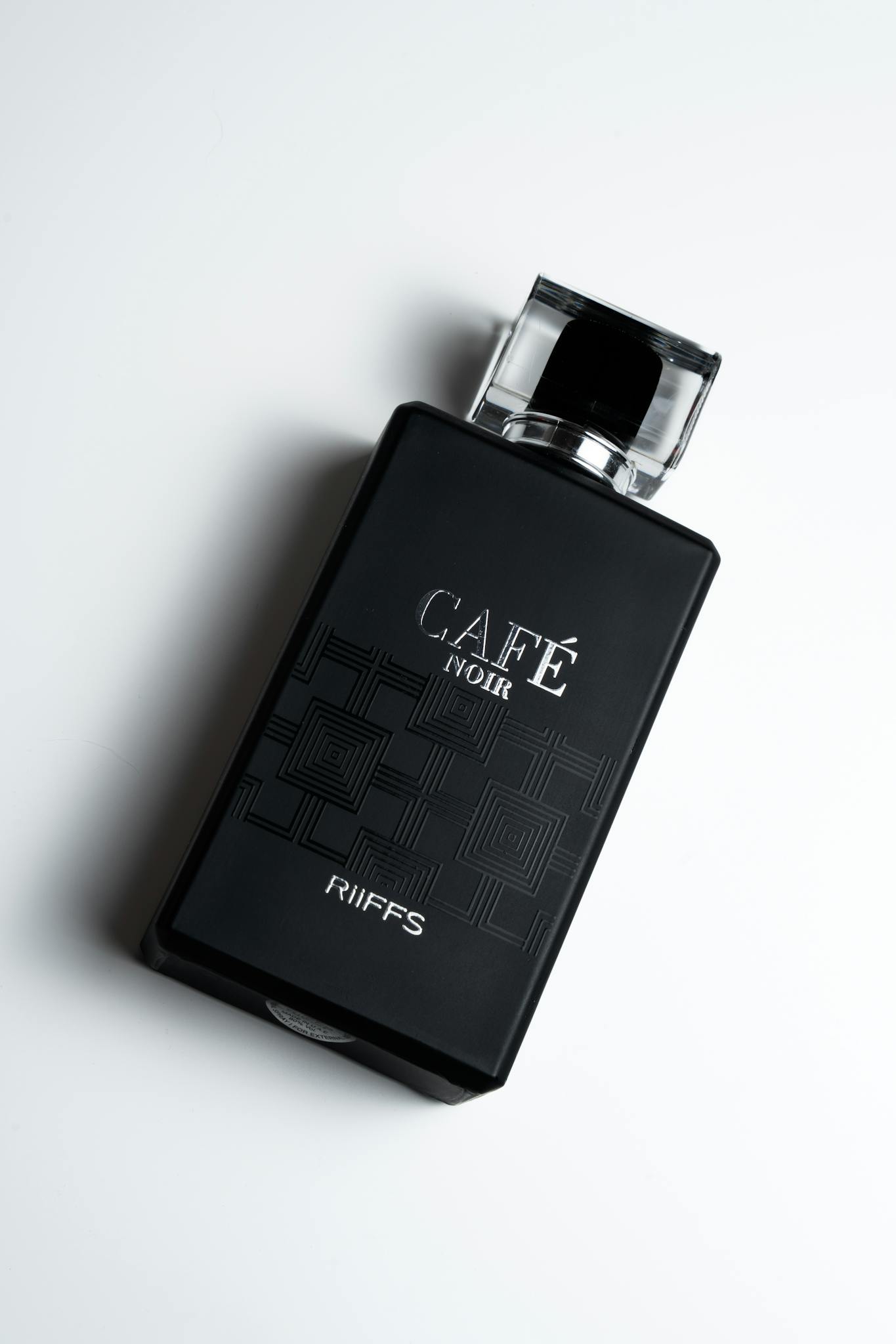 Elegant black perfume bottle shot with artistic design and high-end appeal.