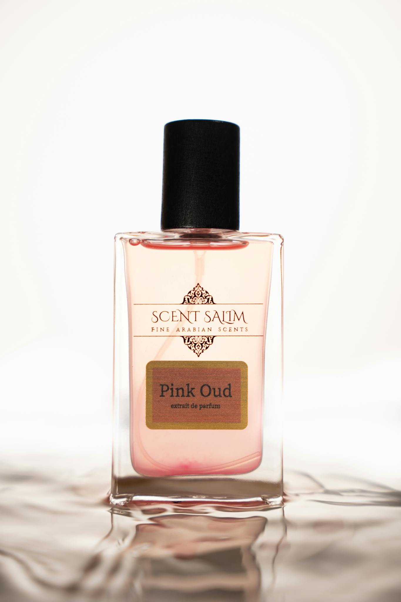 Elegant luxury perfume bottle featuring Pink Oud scent with fine Arabian design.
